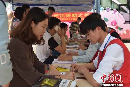 资料图：大学生在爱心献血点咨询献血活动。　邓天运 摄